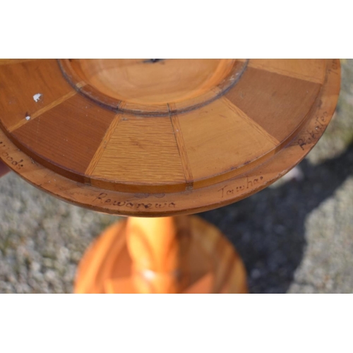 1059 - An antique mahogany cake stand; together with a New Zealand specimen wood torchere.