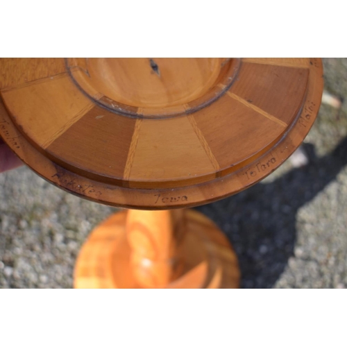 1059 - An antique mahogany cake stand; together with a New Zealand specimen wood torchere.