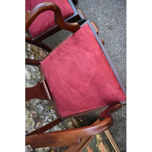 1069 - A set of six mahogany 1920s dining chairs; to include two carvers. 