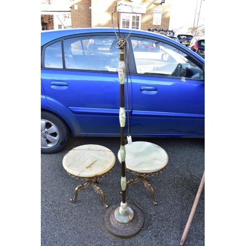 1072 - A pair of onyx tables having gilt metal bases; together with an onyx standard lamp.