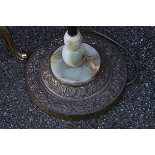 1072 - A pair of onyx tables having gilt metal bases; together with an onyx standard lamp.