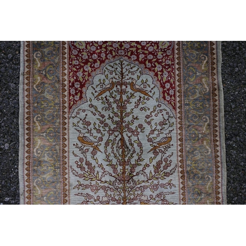 1078 - A small Persian silk prayer rug, decorated with birds, trees and flowers, 72cm x 52cm.... 