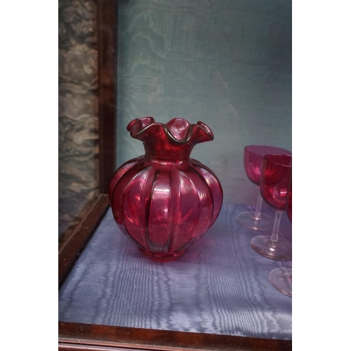 1085 - A collection of Victorian cranberry glass, to include: vases and two electroplate mounted casters. (... 