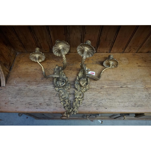 1088 - A pair of rococo style gilt brass twin branch wall lights, 44cm high.