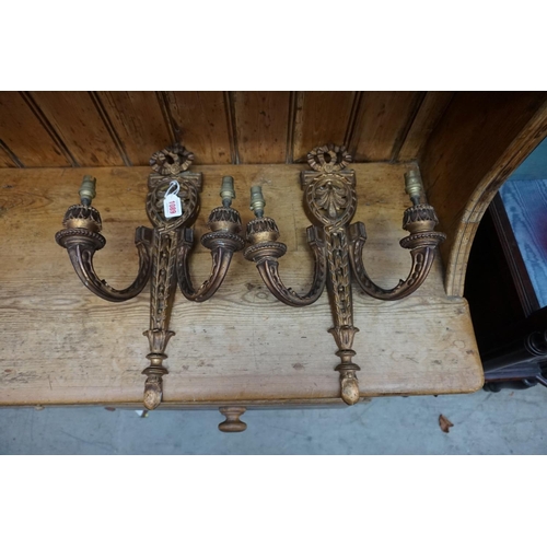 1089 - A pair of neo-classical style carved giltwood twin branch wall lights, 44.5cm long.