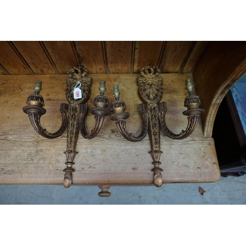 1089 - A pair of neo-classical style carved giltwood twin branch wall lights, 44.5cm long.