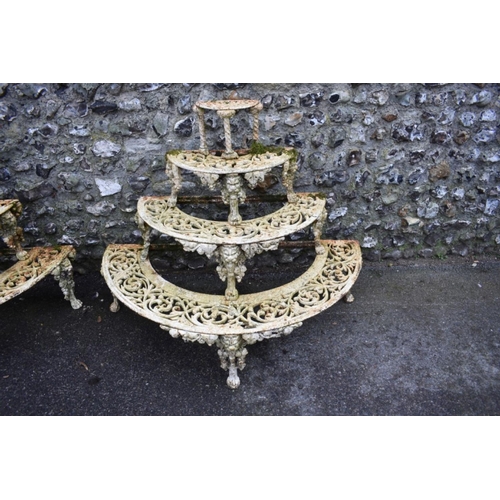 1717 - A pair of Victorian white painted cast iron four tier semi-circular plant stands, in the manner of C... 