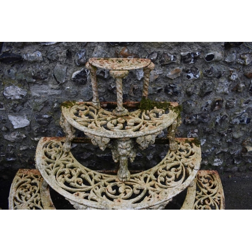 1717 - A pair of Victorian white painted cast iron four tier semi-circular plant stands, in the manner of C... 