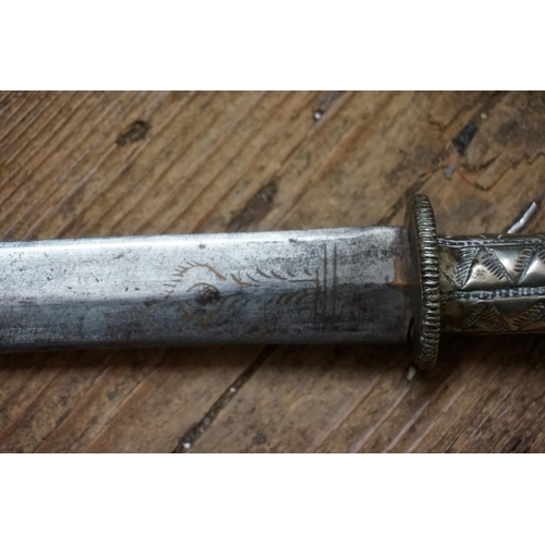 1759 - An Eastern dagger and sheath, with white metal mounts, 29.5cm blade.  