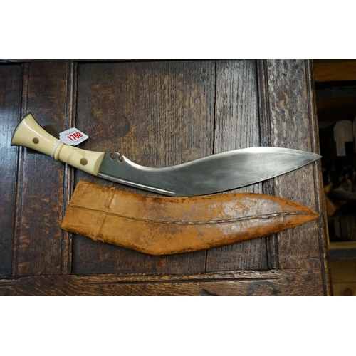 1760 - A large kukri and leather sheath, with ivory scales, 31cm blade.