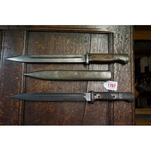 1767 - A German bayonet and steel scabbard; together with another similar bayonet. 