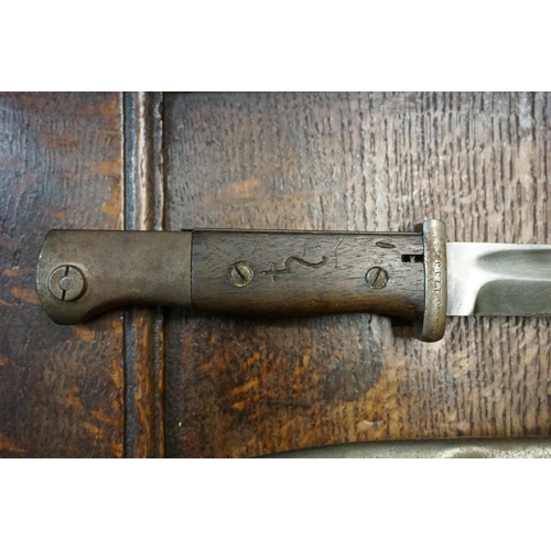 1767 - A German bayonet and steel scabbard; together with another similar bayonet. 