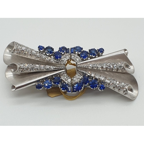 11 - (NB) A satin textured brooch/double clip set diamonds and sapphires, by Alabaster & Wilson, stam... 