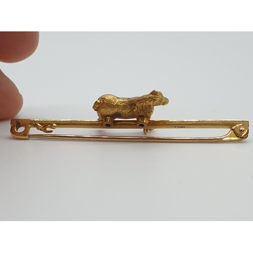 34 - (NB) A horse bar brooch, stamped 15ct, 50mm wide, gross weight 6.8g.