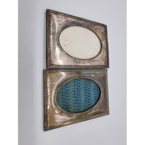 614 - A pair of metal photograph frames, having oval apertures and beaded borders, 18 x 13cm.... 