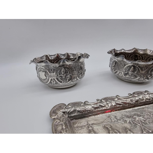 619 - A quantity of Eastern metalware; to include a pair of bowl and a four piece dressing table set. (7)... 