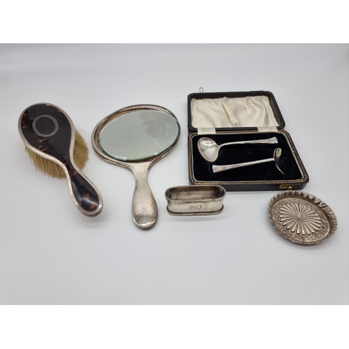 622 - A silver and tortoiseshell hand mirror and matching brush; together with a silver napkin ring; a sil... 