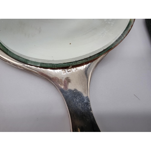 622 - A silver and tortoiseshell hand mirror and matching brush; together with a silver napkin ring; a sil... 