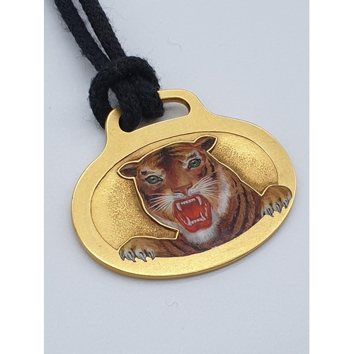 69 - (NB) A 1960s American yellow metal pendant, decorated with enamelled tiger's head, maker A G, stampe... 