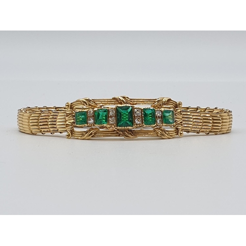 72 - (NB) A late 19th century yellow metal reeded link bracelet, set with five rectangular Columbian emer... 