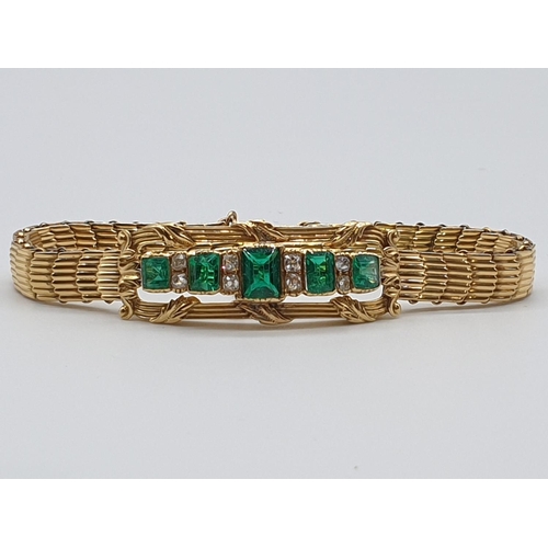 72 - (NB) A late 19th century yellow metal reeded link bracelet, set with five rectangular Columbian emer... 