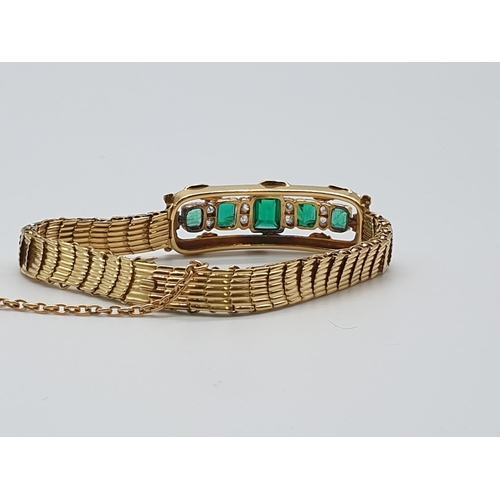 72 - (NB) A late 19th century yellow metal reeded link bracelet, set with five rectangular Columbian emer... 