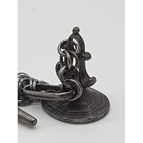 73 - (NB) An 18th century cut steel watch fob chain, 27cm; and an attached steel seal engraved the arms o... 