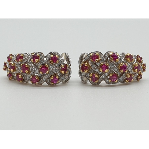 75 - (NB) A pair of 1970s white and yellow metal diamond and ruby lattice work ear clips, set with approx... 