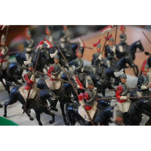 869 - Britains: fourteen vintage lead Britains mounted Life Guards and Horse Guards; together with four mo... 