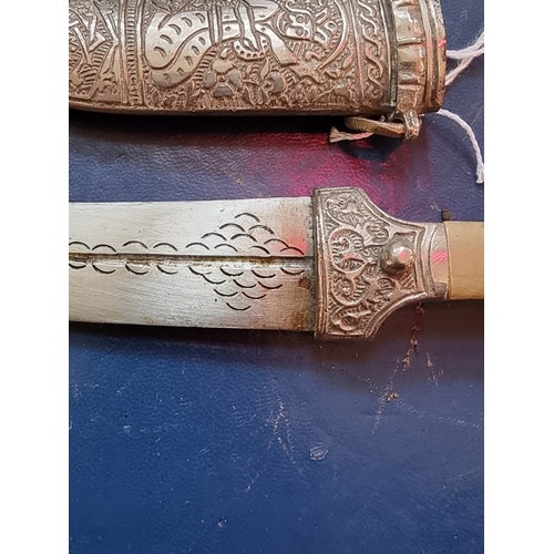 1766 - Two large kukris and sheaths; together with a Indo-Persian jambiya and metal sheath.... 