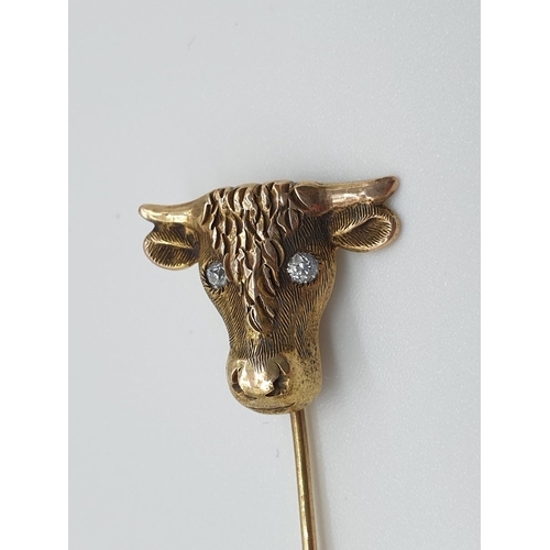 16 - (NB) A late Victorian yellow metal stickpin, the terminal decorated Taurus with diamond set eyes, th... 