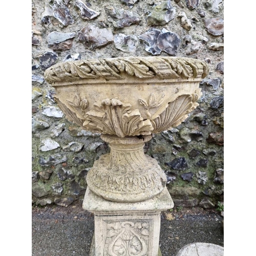 1022 - A pair of reconstituted stone bird baths; together with two similar smaller urns. ... 