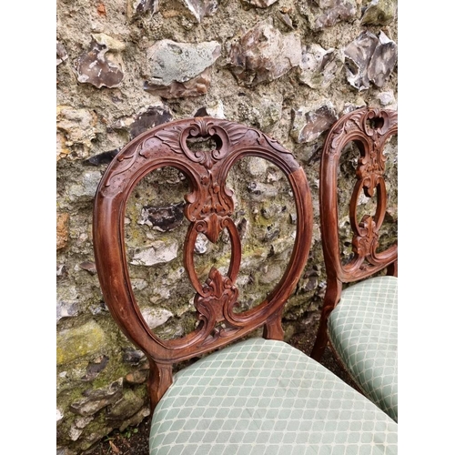 1039 - A set of eleven antique carved walnut dining chairs. 