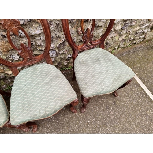 1039 - A set of eleven antique carved walnut dining chairs. 