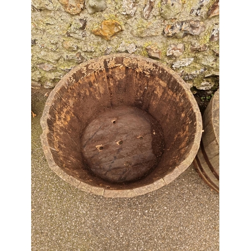 1043 - A pair of coopered wood and metal bound planters.