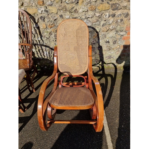 1061 - A bentwood and cane rocking chair. 