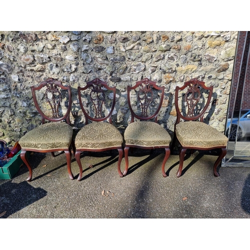 1071 - A set of four mahogany shield back dining chairs. 