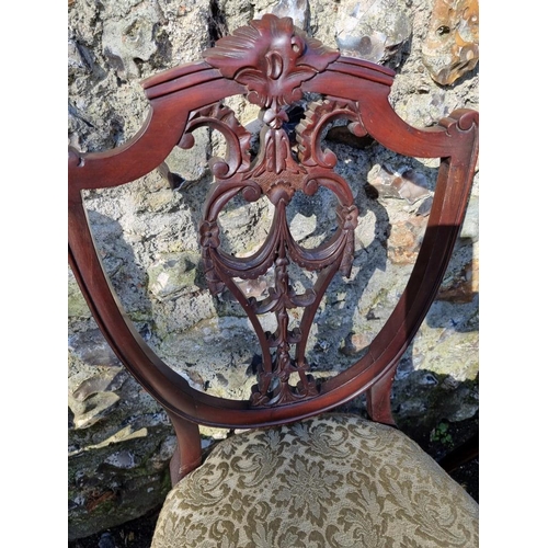 1071 - A set of four mahogany shield back dining chairs. 