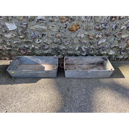 1084 - A pair of galvanised metal troughs.