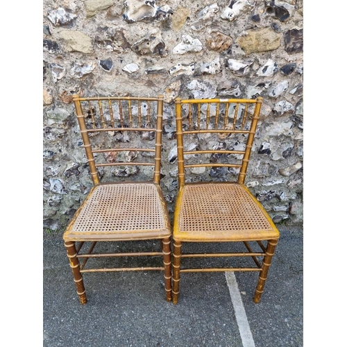 1097 - A pair of faux bamboo cane seated chairs. 