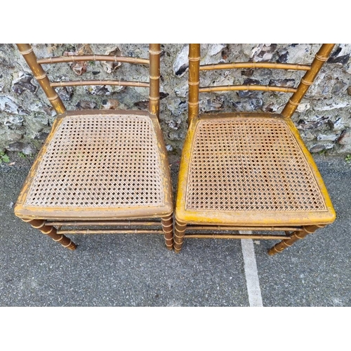 1097 - A pair of faux bamboo cane seated chairs. 