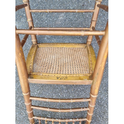 1097 - A pair of faux bamboo cane seated chairs. 