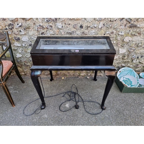 1103 - A black painted double sided bijouterie table, missing key, 85cm wide x 88cm high.