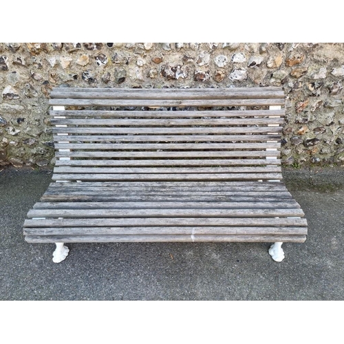 1114 - A Victorian cast iron bench, having wooden slats, 130cm wide.