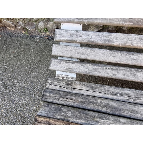 1114 - A Victorian cast iron bench, having wooden slats, 130cm wide.