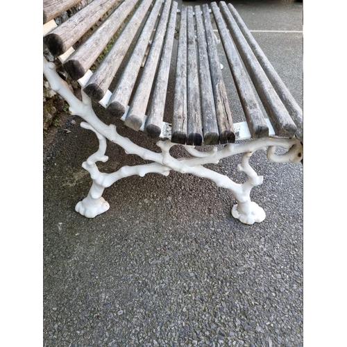 1114 - A Victorian cast iron bench, having wooden slats, 130cm wide.