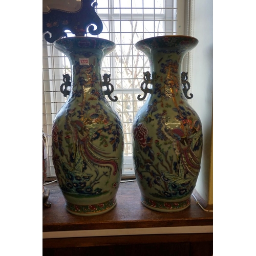 1773 - A large pair of Chinese famille rose celadon ground twin handled vases, decorated with pheasants and... 