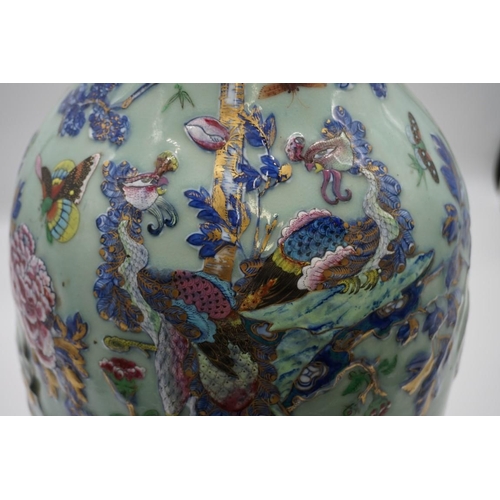 1773 - A large pair of Chinese famille rose celadon ground twin handled vases, decorated with pheasants and... 