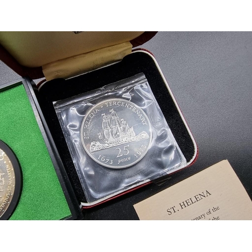 855 - Coins: a cased Royal Mint silver proof St Helena 1973 tercentenary crown; together with three other ... 