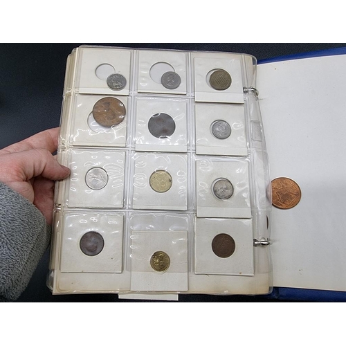 861 - Coins: an album of UK and world coins, to include a George V 1935 rocking horse crown.... 